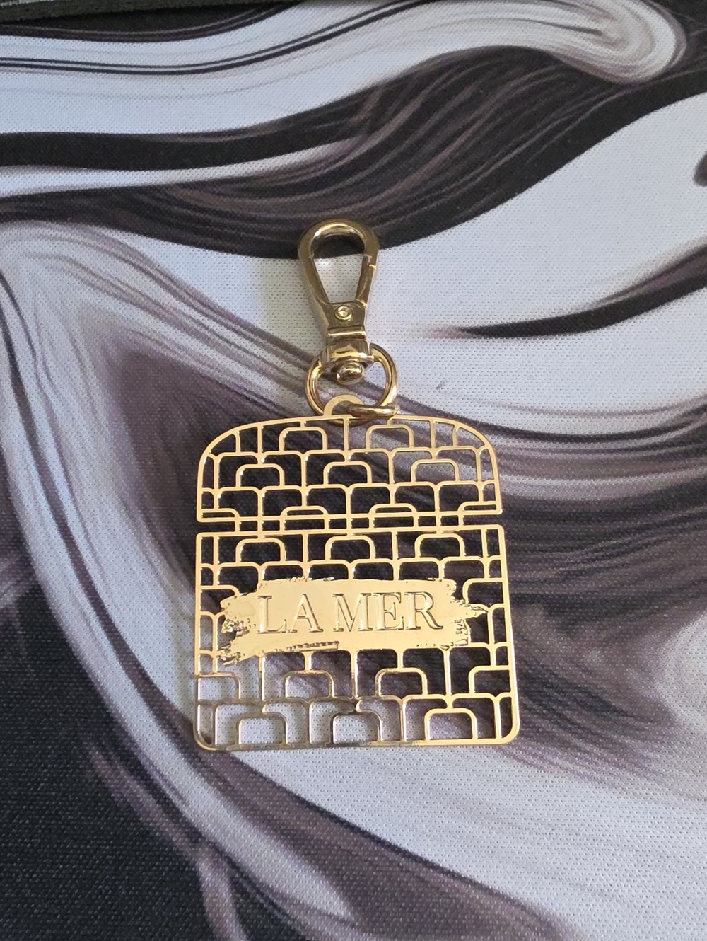 La Mer Gold-Tone Filigree Bag Charm with Logo